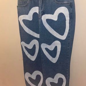 Dark wash jeans with bleached hearts
